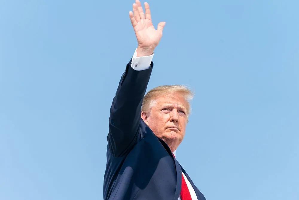 Donald Trump waving with blue background