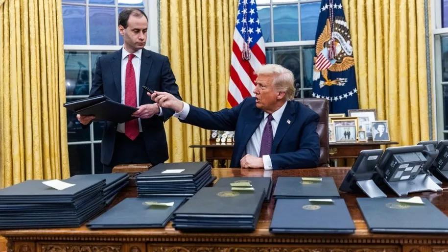 US President Donald Trump in Oval Office White House signing executive orders on crypto and AI