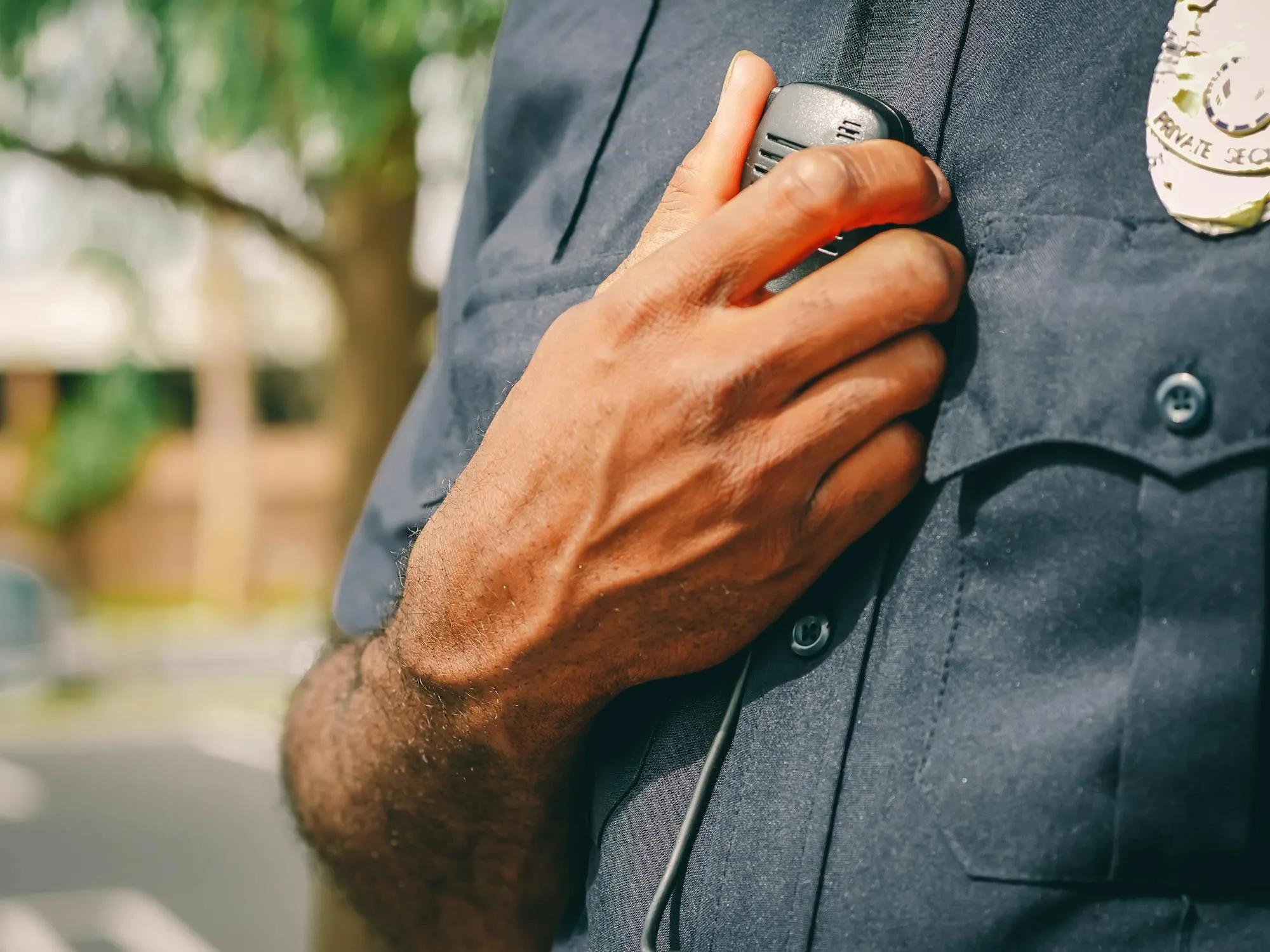 A close up photo of a policeman's uniform and radio