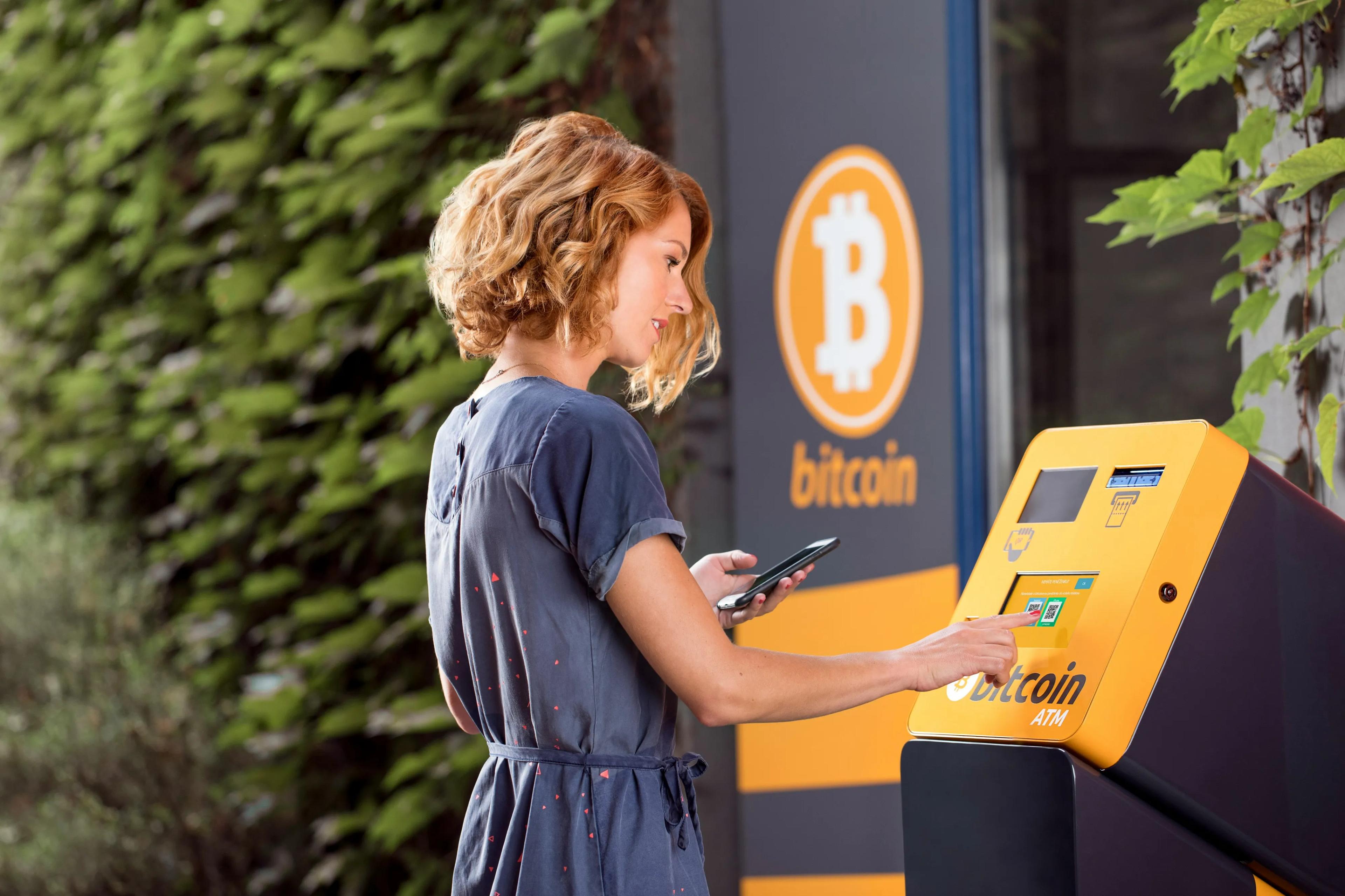 A woman using a Bitcoin ATM