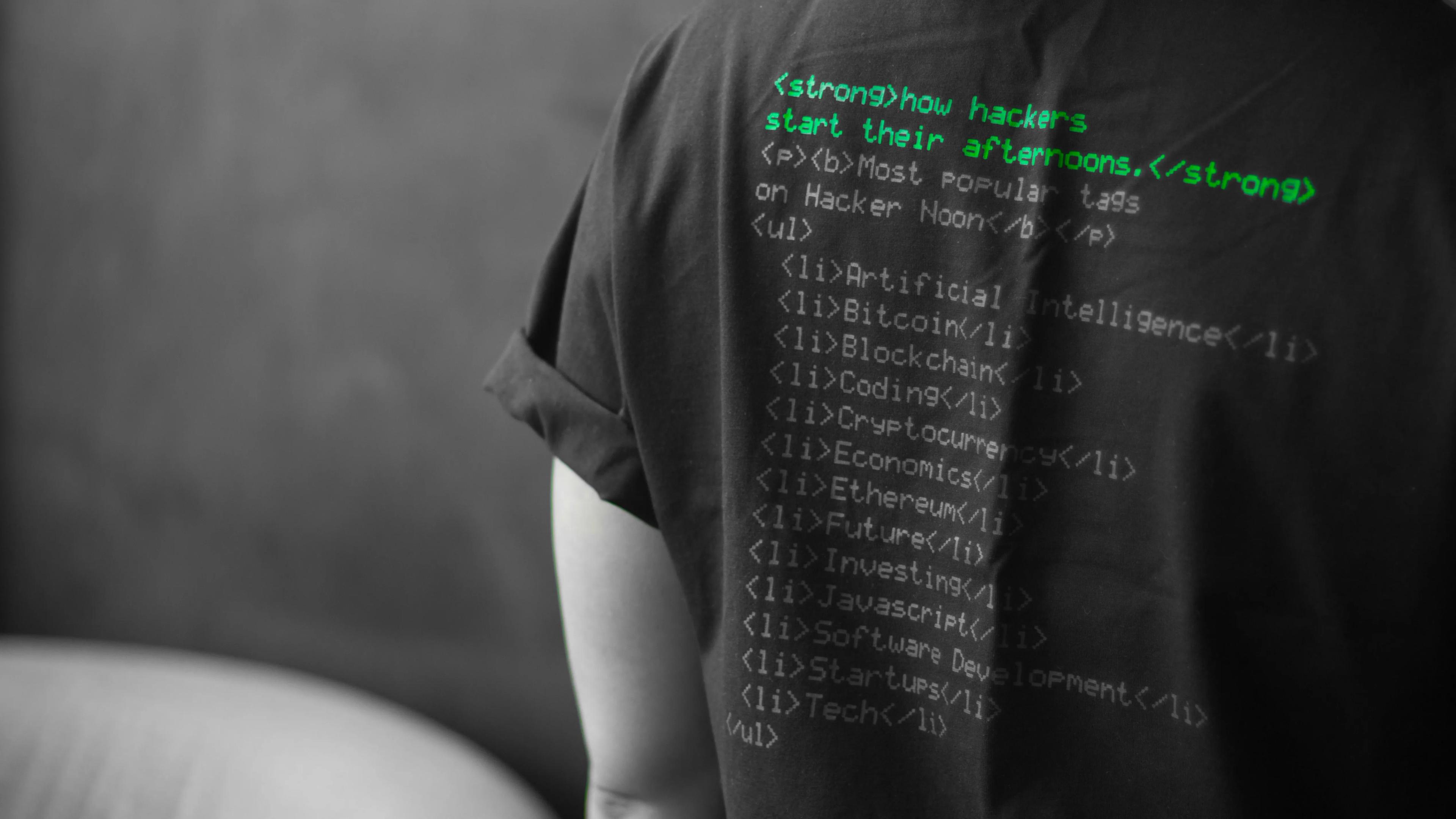 Black t-shirt featuring hacking code printed on the back, symbolizing cybersecurity and digital hacking concepts