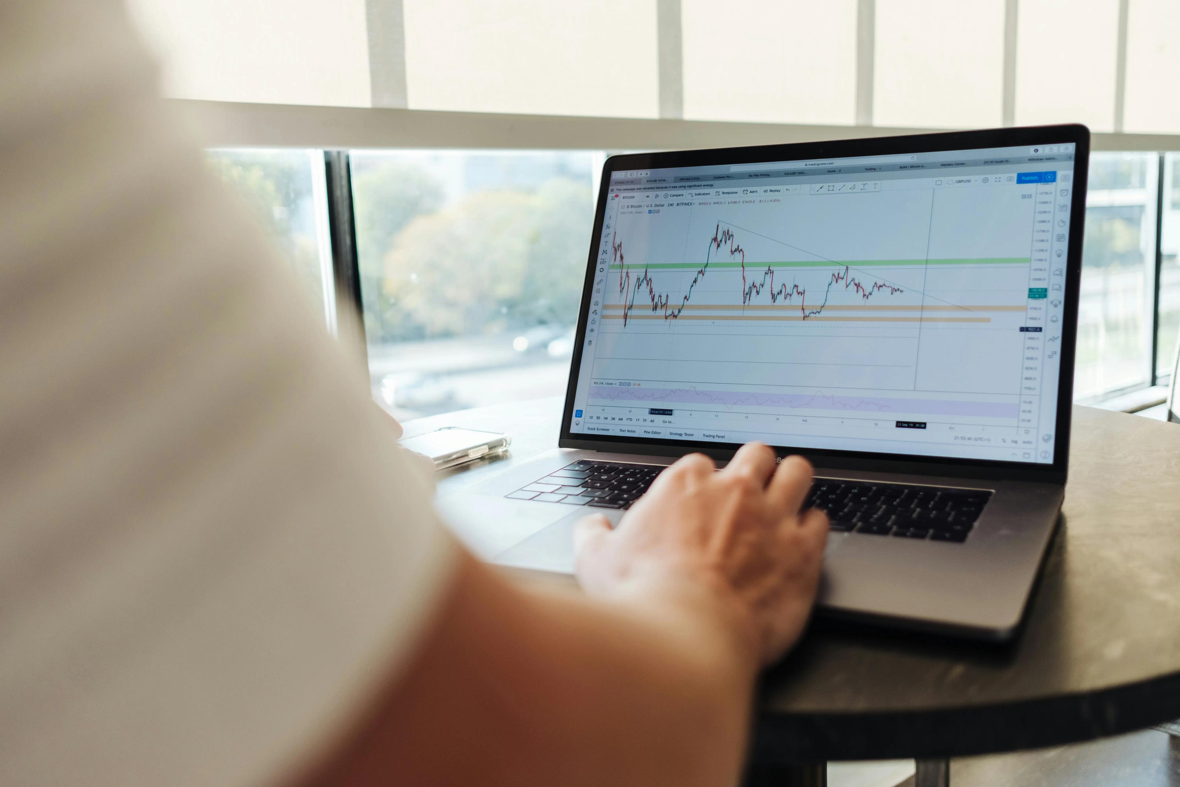 Cryptocurrency price chart open on a trader's laptop