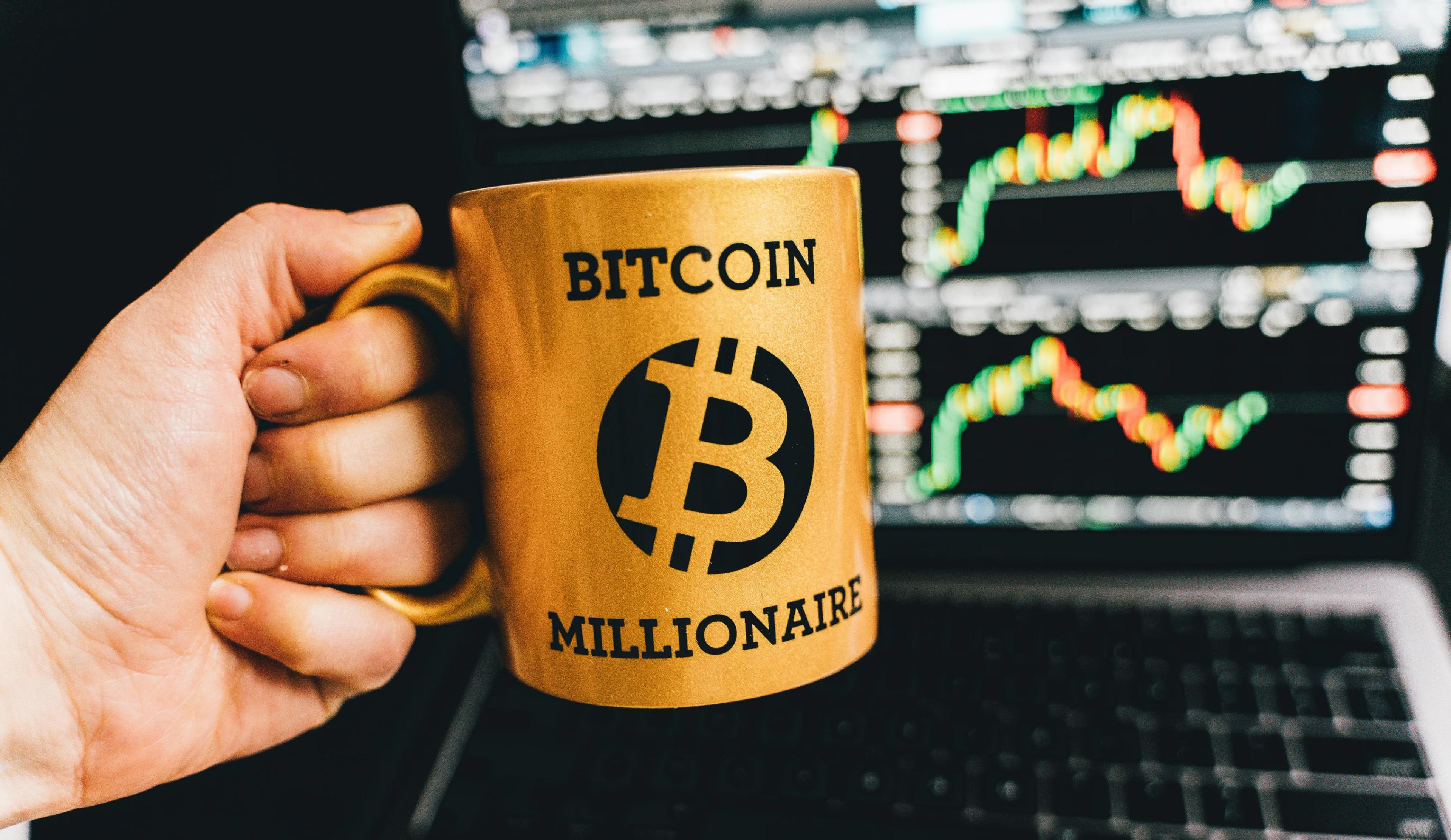 A yellow mug that says Bitcoin Millionaire in black