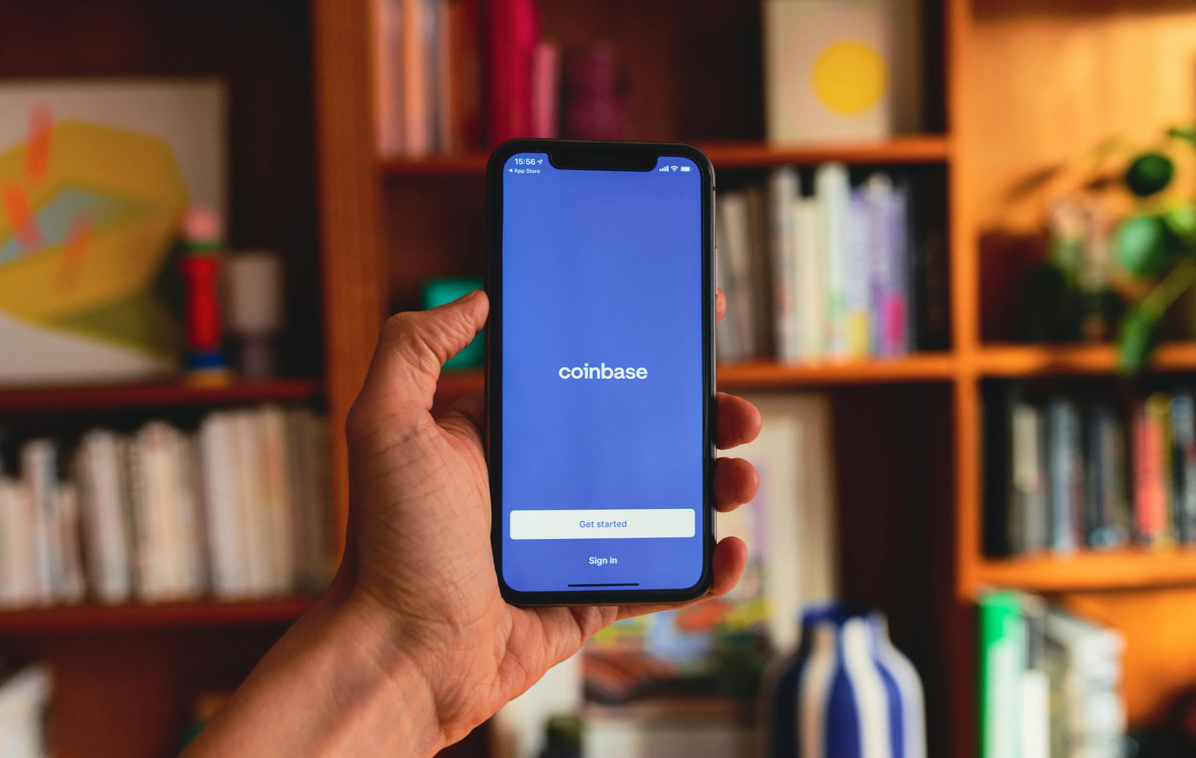 A smartphone with blue Coinbase app open on screen